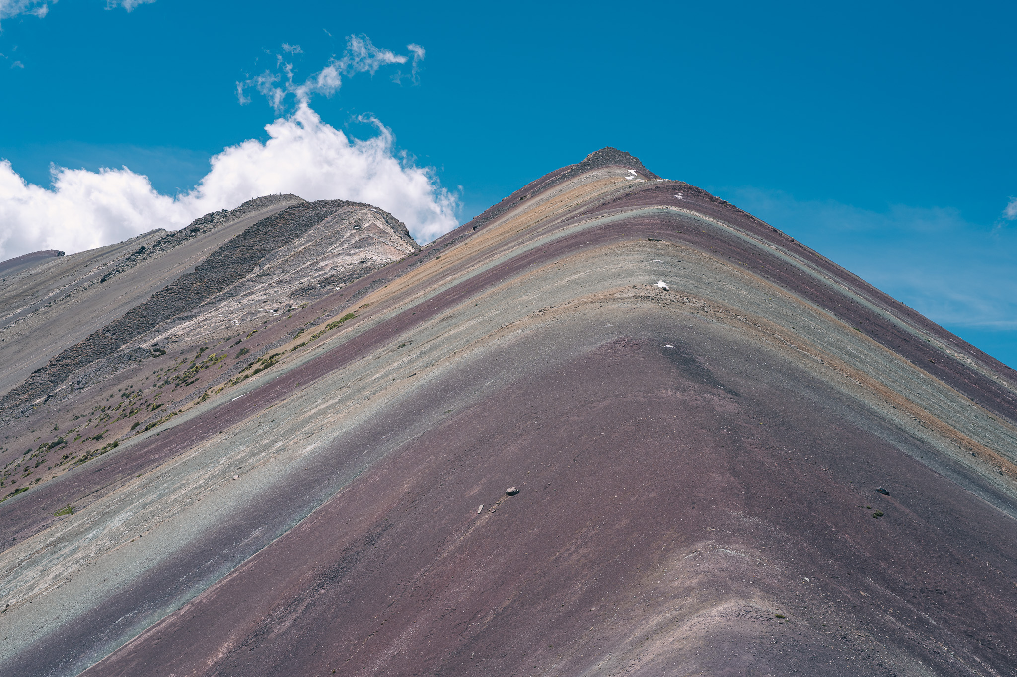 Striped mountain ridge under blue sky