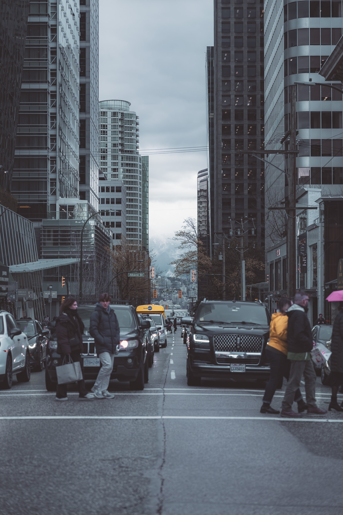 Downtown street scene between tall buildings